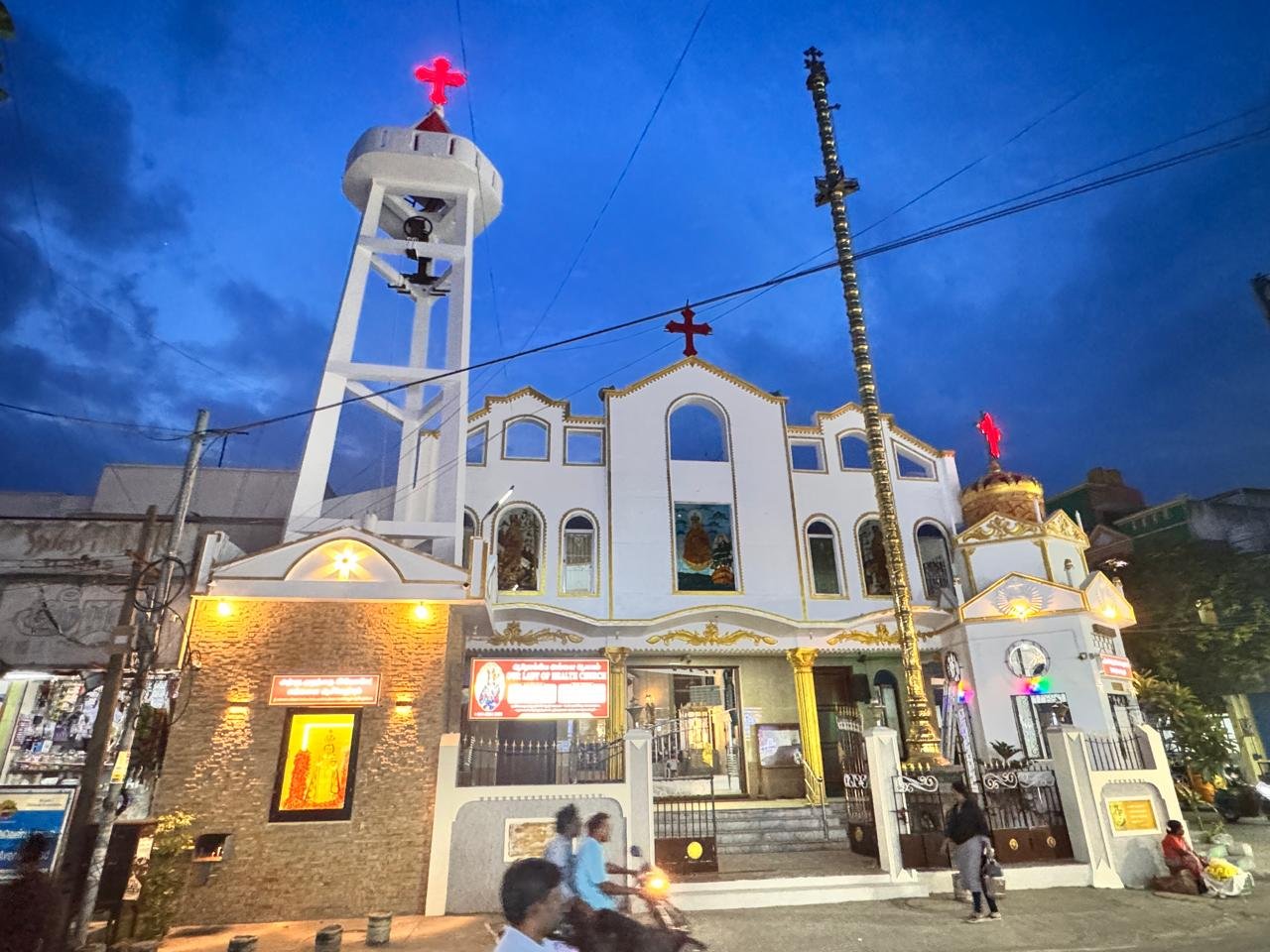 The church and bell tower seen from the street in the evening